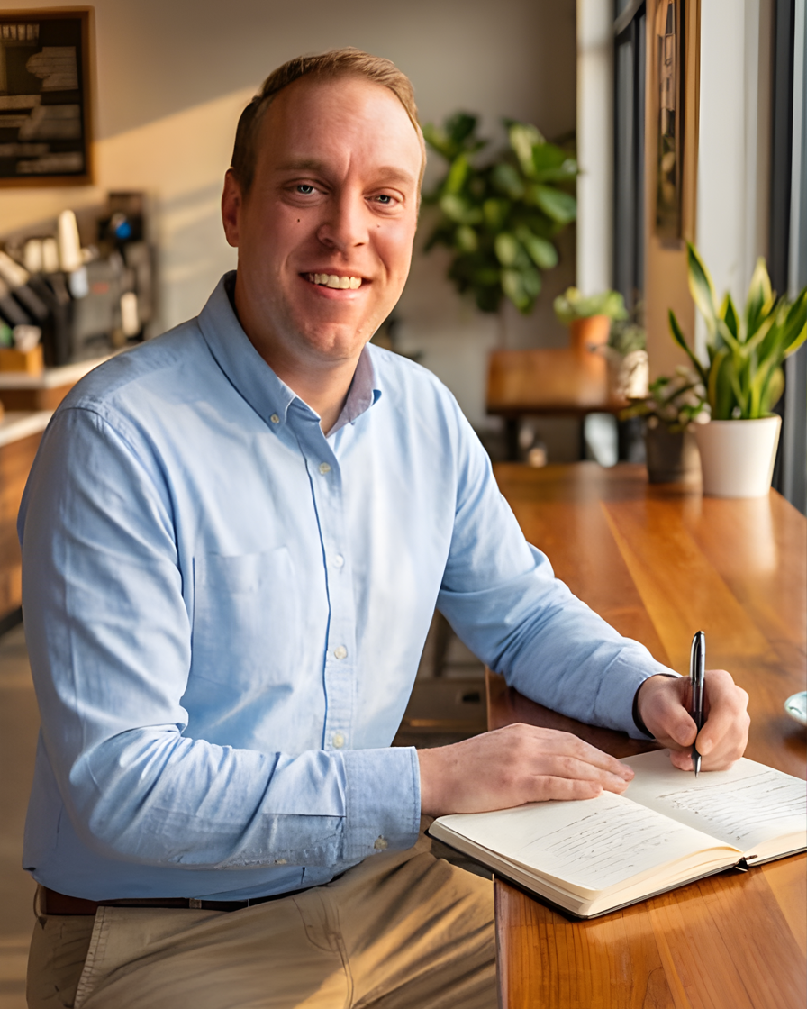 Greg Girard, founder of MyBizzz, in a sunlit Calgary workspace